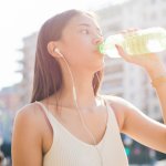 young woman drinking bottled water