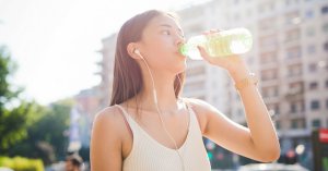 young woman drinking bottled water